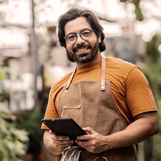 Small business person using tablet to bank.