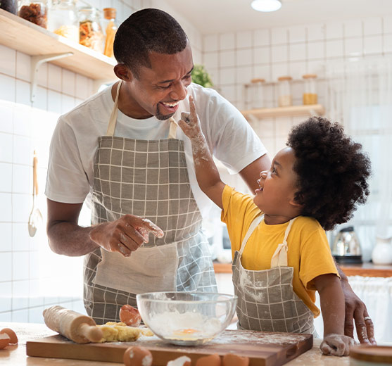 Dad and child baking with aprons on