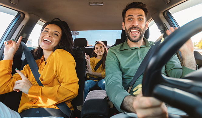 Family in car smiling