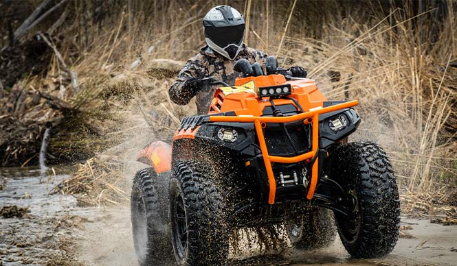 ATV flying through the muddy trail