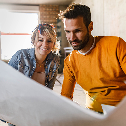 Couple looking at home improvement plans.