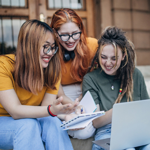 College students looking at a laptop.