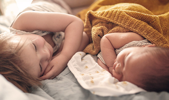 two babies laying together.