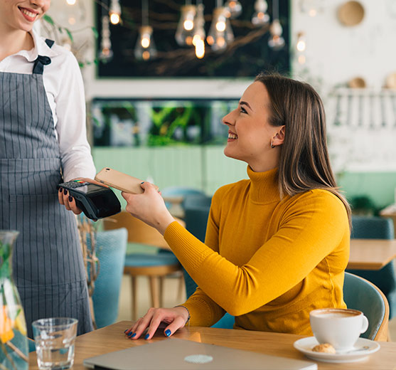 woman paying for her coffee with her phone
