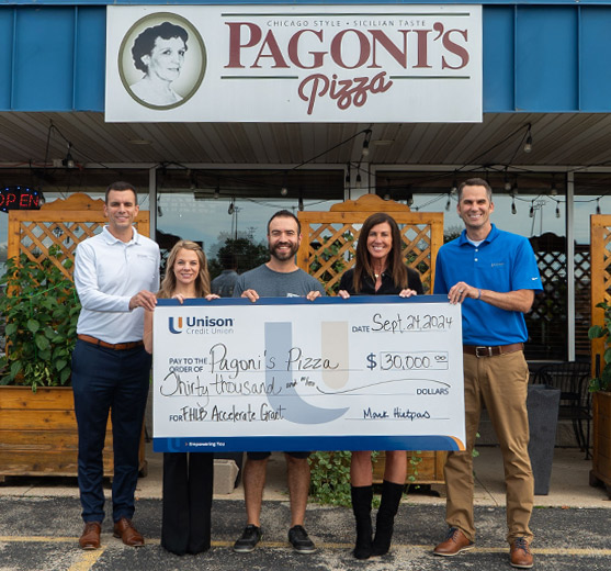 Unison presenting a check to Pagoni's Pizza