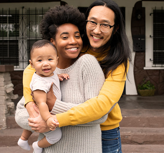 Young family hugging