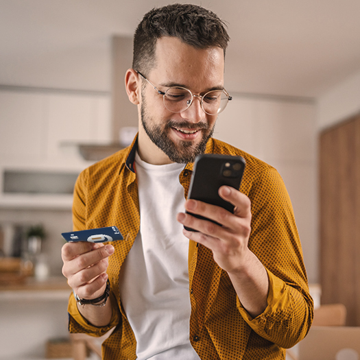 Adult man at home shopping online using debit card to online shop