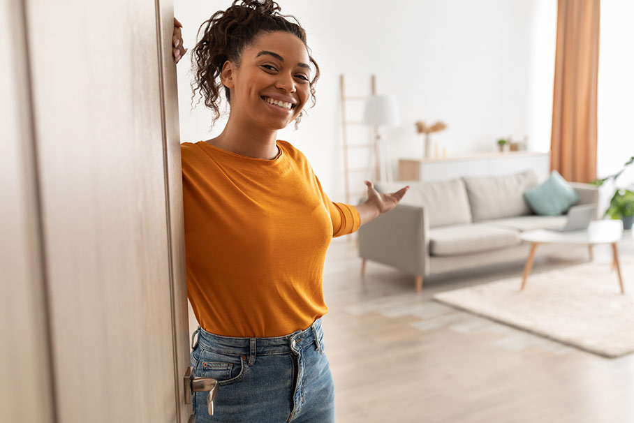 Woman opening the door to her home