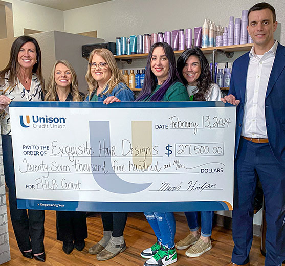 Unison Credit Union presenting Exquisite Hair Designs a check