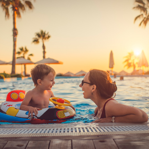 Mother and child in a pool on vacation.