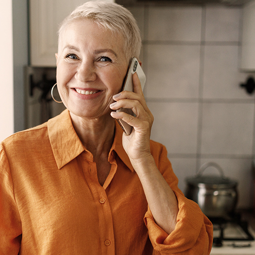 Joyful grandmother talking on the phone