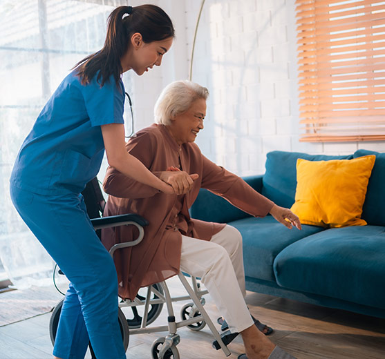 Nurse helping elderly woman to stand up