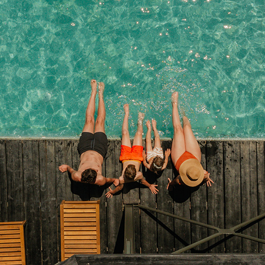 Family sitting by a new pool.
