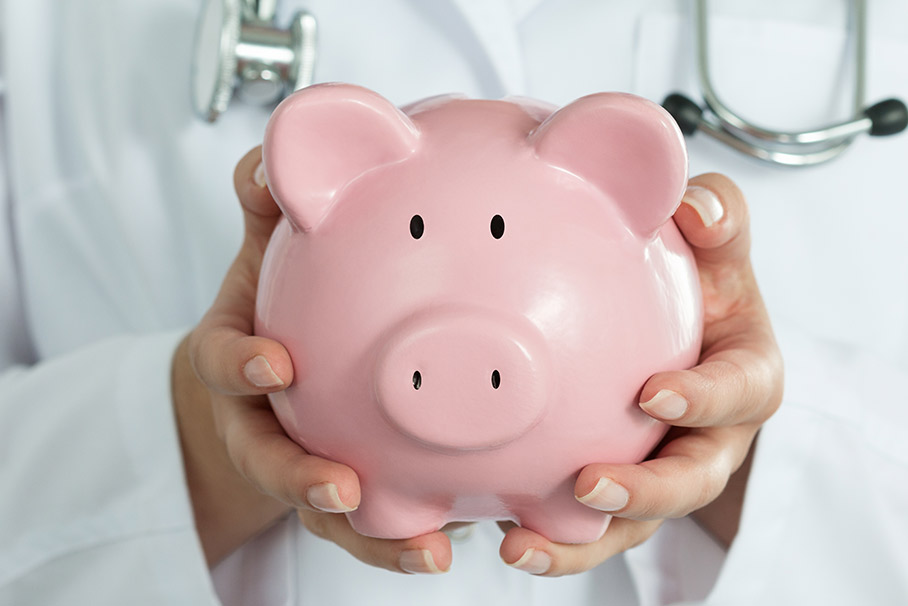 Doctor Holding Piggy Bank