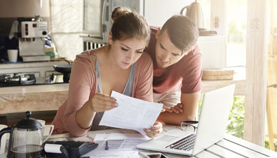 man and woman looking through finances