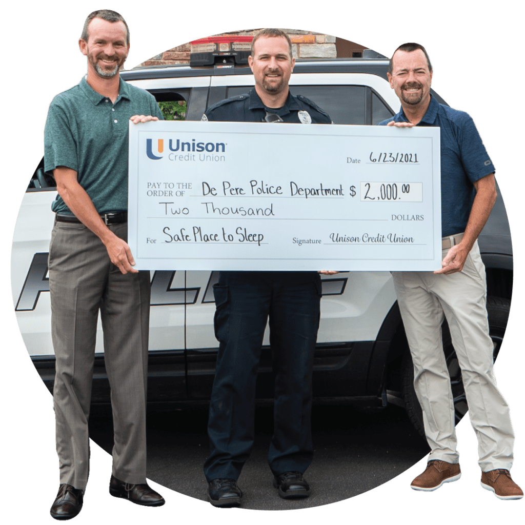 Three men holding oversized check