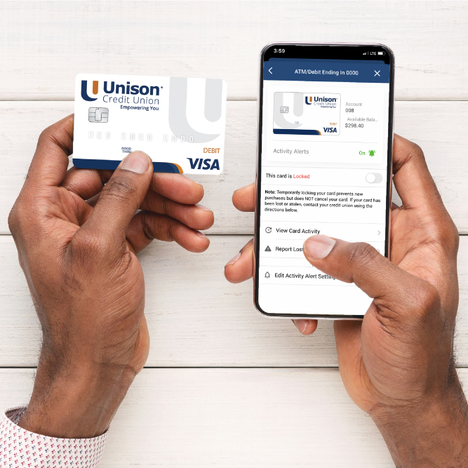 5 Best Practices To Protect Yourself From Fraud - Man holding his Unison Debit Card and turning reporting fraud on mobile app Square