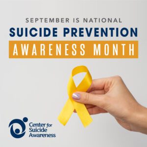 Suicide Awareness Month - Hand Holding yellow ribbon
